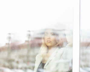 Young beautiful successful business woman standing near the wind