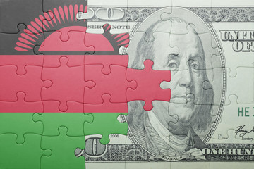 Fototapeta na wymiar puzzle with the national flag of malawi and dollar banknote
