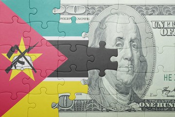puzzle with the national flag of mozambique and dollar banknote