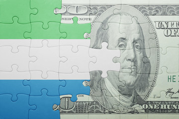 puzzle with the national flag of sierra leone and dollar banknote