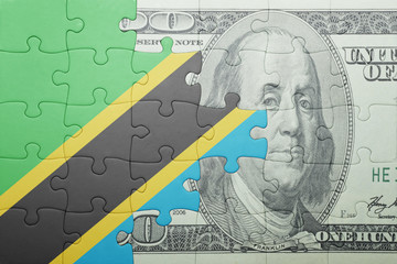 puzzle with the national flag of tanzania and dollar banknote