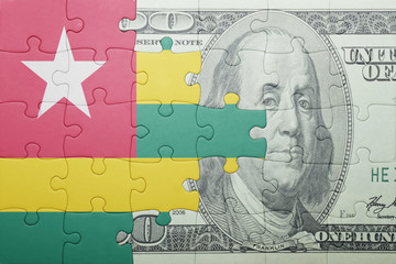 puzzle with the national flag of togo and dollar banknote