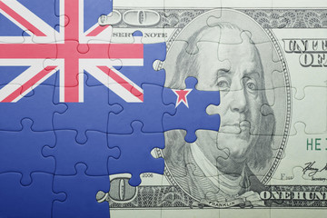 puzzle with the national flag of new zealand and dollar banknote