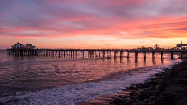 Twilight time lapse view with zoom of Malibu Pier near Los Angeles, California. 