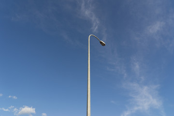 blue sky with white lamp pole