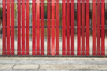 red painted wooden fence panels.