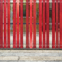 red painted wooden fence panels.