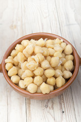 Chickpeas on glass bowl on wooden table