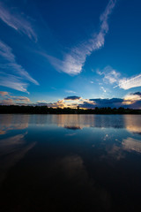 blue evening sky and smooth water surface