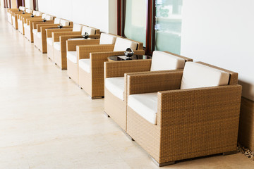 Patio with an outdoor sofa and table against the red brick wall.