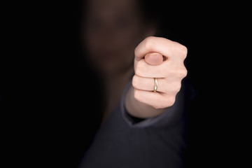 Woman's hand with a ring shows fig gesture