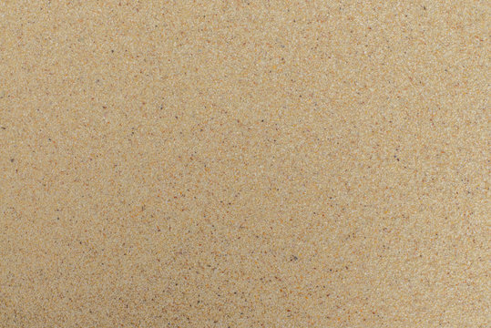 closeup of sand pattern of a beach in the summer. Beach background. Top view