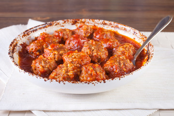 meatballs in tomato sauce in a bowl on a table, selective focus