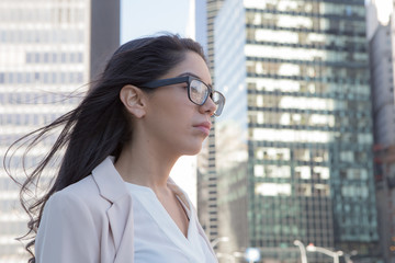 Fototapeta premium Young latin professional woman with glasses in the city