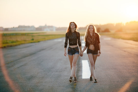Two young girlfriends walking