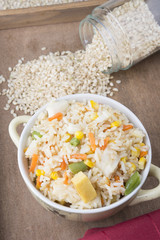 Rice with vegetables on white background