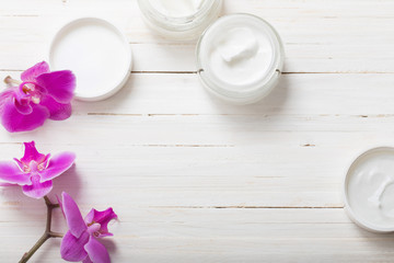 cream and pink orchid flowers on white wooden background