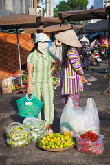 Two vietnamese women are having a conversation at the street market, Nha Trang, Vietnam on December 02, 2015.