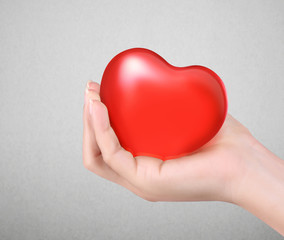 Fototapeta premium Red heart in hands