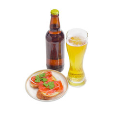 Lager beer and sandwiches with salted trout on light background