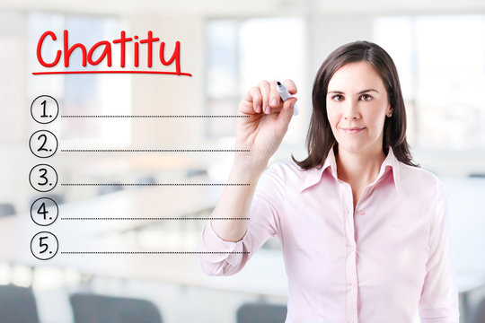Business woman writing blank Charity list. Office background. 