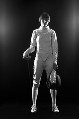 Fototapeta na wymiar The portrait of woman wearing white fencing costume on black 