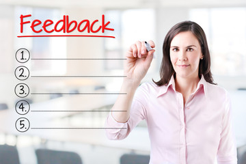 Business woman writing blank Feedback list. Office background. 