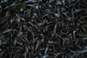 Homemade uncooked black squid ink tagliatelle