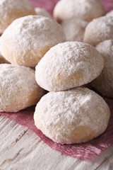 polvorón cookies with powdered sugar macro on a table. Vertical
