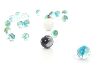 glass marbles balls on white blackground ,selective focus