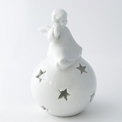 A statuette of an angel on the ball with stars