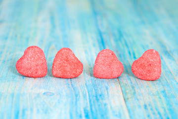 Obraz na płótnie Canvas heart candies coated with sugar sitting on table.selective focus