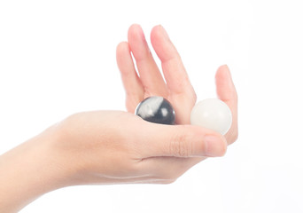 Human hand hold glass marbles balls on white blackground, selective focus