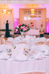 Table set for an event party or wedding reception, spring theme