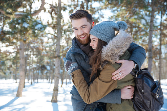 Couple hugging in winter park