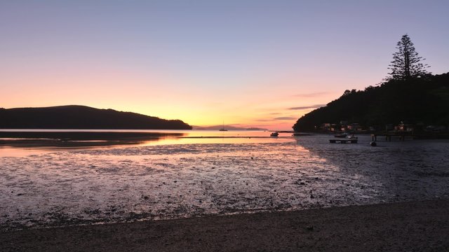 Time lapse of sunrise landscape over Sandspit beach near Warkworth New Zealand