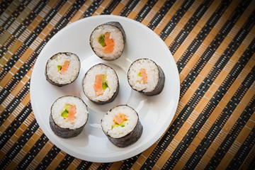 Rolls with salmon in white dish. Selective focus.