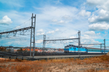 train rides on rails along the city