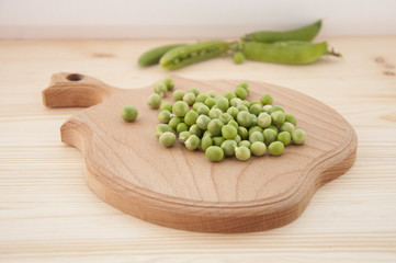 Green peas on wooden background