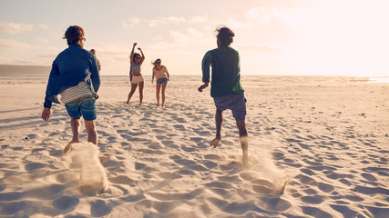 Friends running a race on the beach