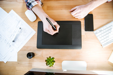Table of graphic designer using pen tablet with stylus