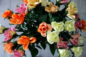 Bouquet of colorful artificial roses in a vase