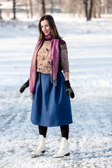 Cheerful girl having fun in winter ice skating.