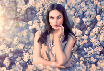 Beauty romantic woman portrait in blooming trees