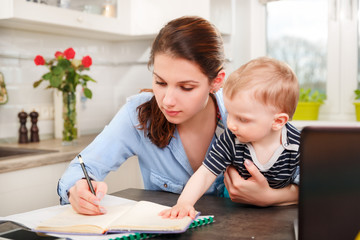 Young mother working with her baby 