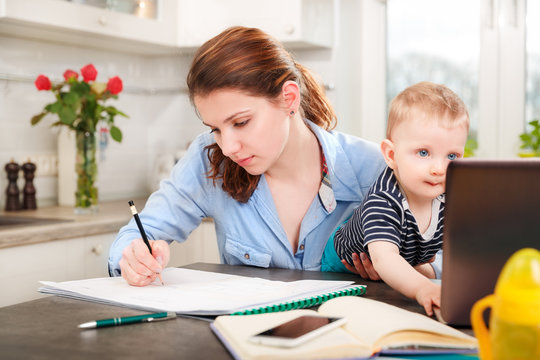 Young mother working with her baby 