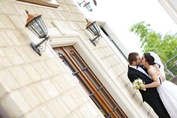 Beautiful bridal couple embracing on wedding day