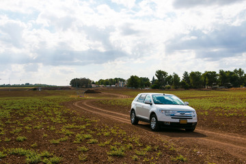 Fototapeta premium White SUV off road, cloudy day
