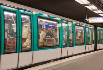 Metro train in a Paris station, France