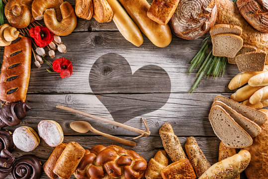 breads, pastries, christmas cake on wooden background with heart, picture for bakery or shop, valentines day